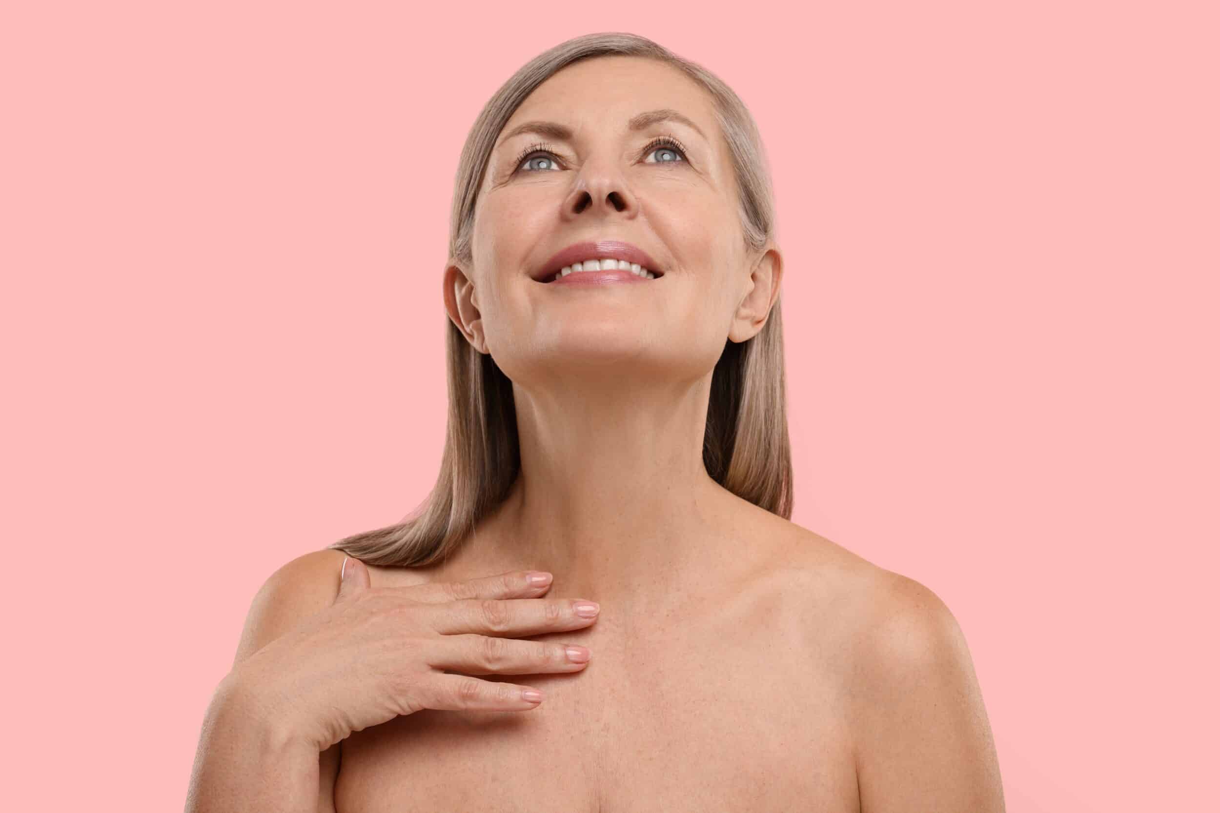 Woman is pleased with the smooth appearance of her neck after removing excess skin with neck lift surgery