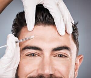 Handsome man with smooth brow receives Dysport injection to his forehead.